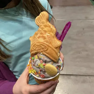 a woman holding a cone of ice cream