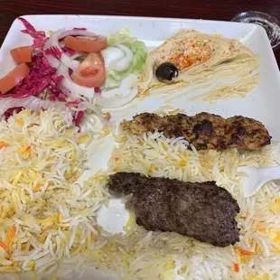 a plate of food with meat, rice and vegetables