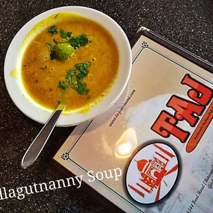 a bowl of soup and a menu