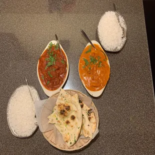 Lamb Vindaloo (Red dish), Gowa Shrimp Curry (Orange dish), Garlic Naan