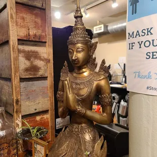 a bronze statue of a buddha