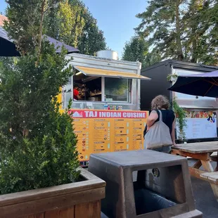 a woman ordering food from a food truck