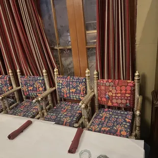 a table with four chairs and a knife