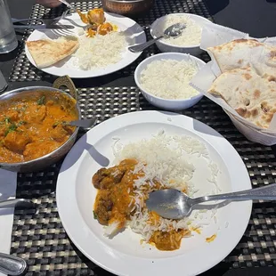 Aloo, Gobi, salmon, curry , basmati, rice,  and naan bread.