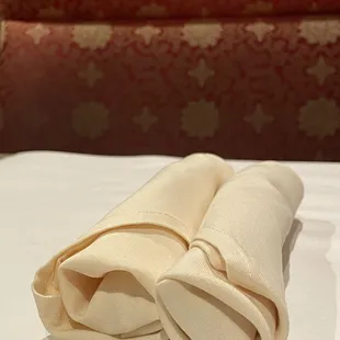 two folded napkins on a table