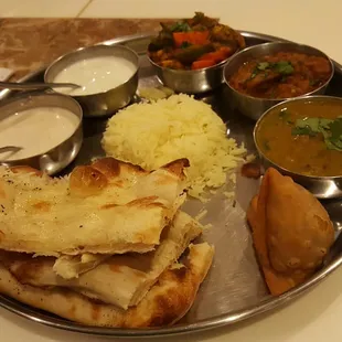 Thali plate (vegetable jalfrezi, eggplant bhartha, lentil, rice, bread, rice pudding)