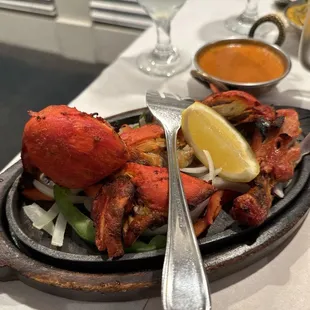 1/2 Tandoori Chicken with the side of sauce in the background.