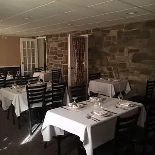 tables with white tablecloths and place settings
