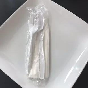 a fork and knife wrapped in plastic