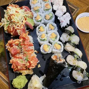a plate of sushi and a bowl of sauce