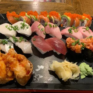 a plate of sushi and rolls