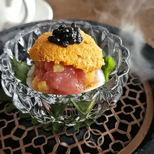Omakase tuna, uni and black caviar on a scallop