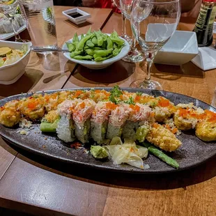 a large platter of sushi on a wooden table