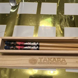 a pair of chopsticks in a wooden box