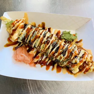 Razorback roll (shrimp tempura, cucumber, avocado eel sauce, spicy mayo and siraca sauce on top)