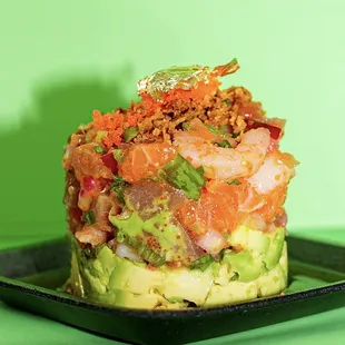 Gold tartar!! 
Avocado base, shrimp, salmon, tuna, scallions, masago, red onion, Garlic ponzu, massi sauce  with 18k edible gold on top.