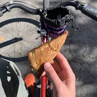 a hand holding a piece of bread