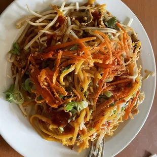 a plate of noodles and carrots
