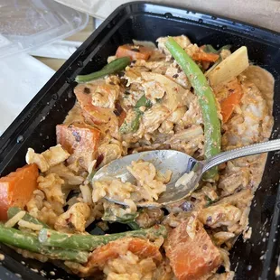 a tray of food with a spoon in it