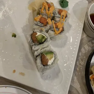 a plate of sushi and sauces