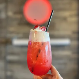 a hand holding a drink