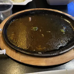 Water left over on plate from being cooked out of the chicken