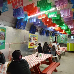 people sitting at tables in a mexican restaurant