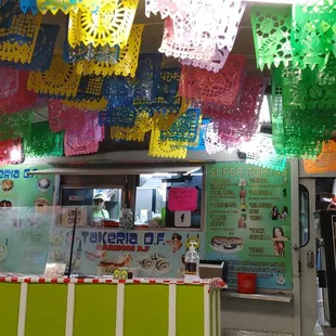 a mexican food stand with colorful decorations