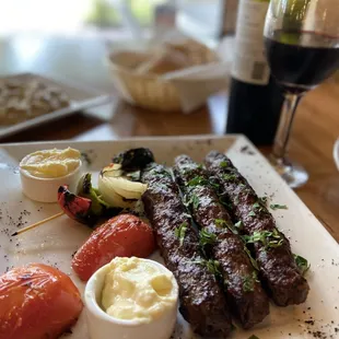 a plate of food and a glass of wine