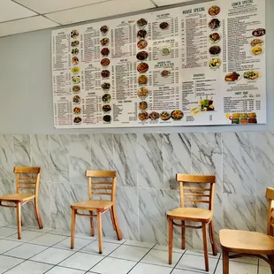 a restaurant with a menu on the wall