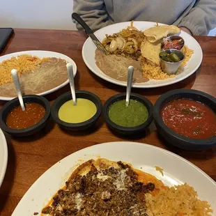 a man sitting at a table with plates of food