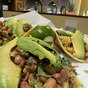 Carnitas Tacos, (whole beans and cilantro toppings) add avocado