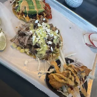 Carnitas taco, fish taco, queso and rajas