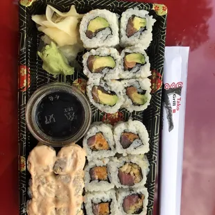 a plate of sushi and a bowl of sauce