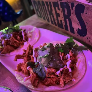 two tacos on a white plate