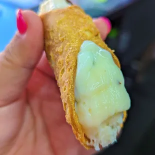 a person holding a piece of food