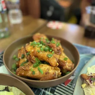 a bowl of chicken wings and tortillas