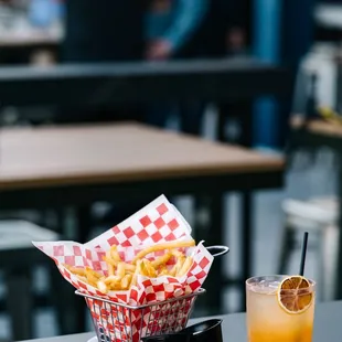 a drink and a basket of french fries