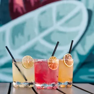 three cocktails on a table