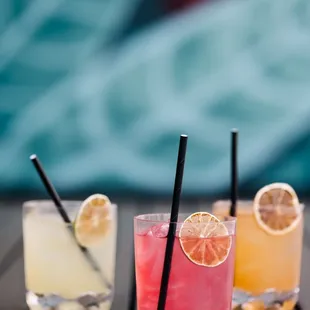 three cocktails on a table