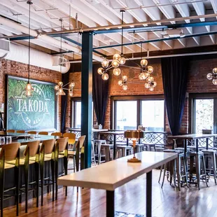 the interior of a restaurant with tables and chairs