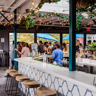 a view of a bar with people sitting at it