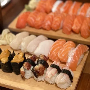 a variety of sushi on wooden trays