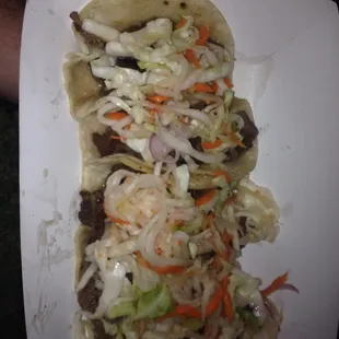 a taco with meat and vegetables