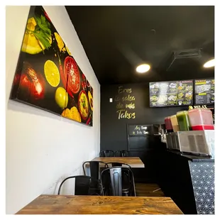 the interior of a restaurant with tables and chairs