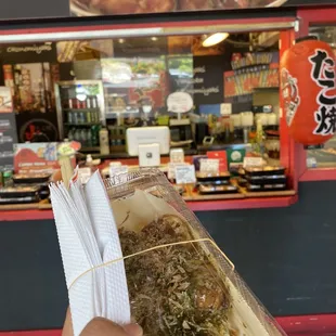 a person holding a piece of food