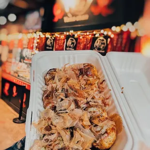 a person holding a tray of food