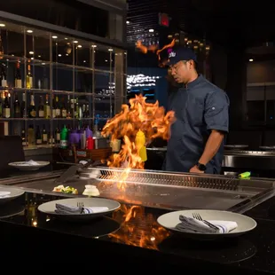 a chef cooking on a grill