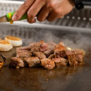 a person cooking on a grill