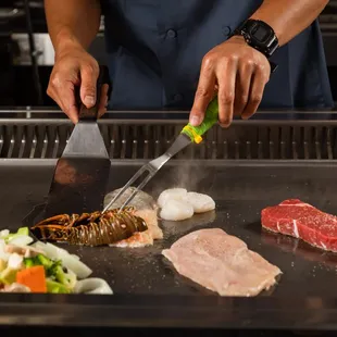 a chef cutting a steak